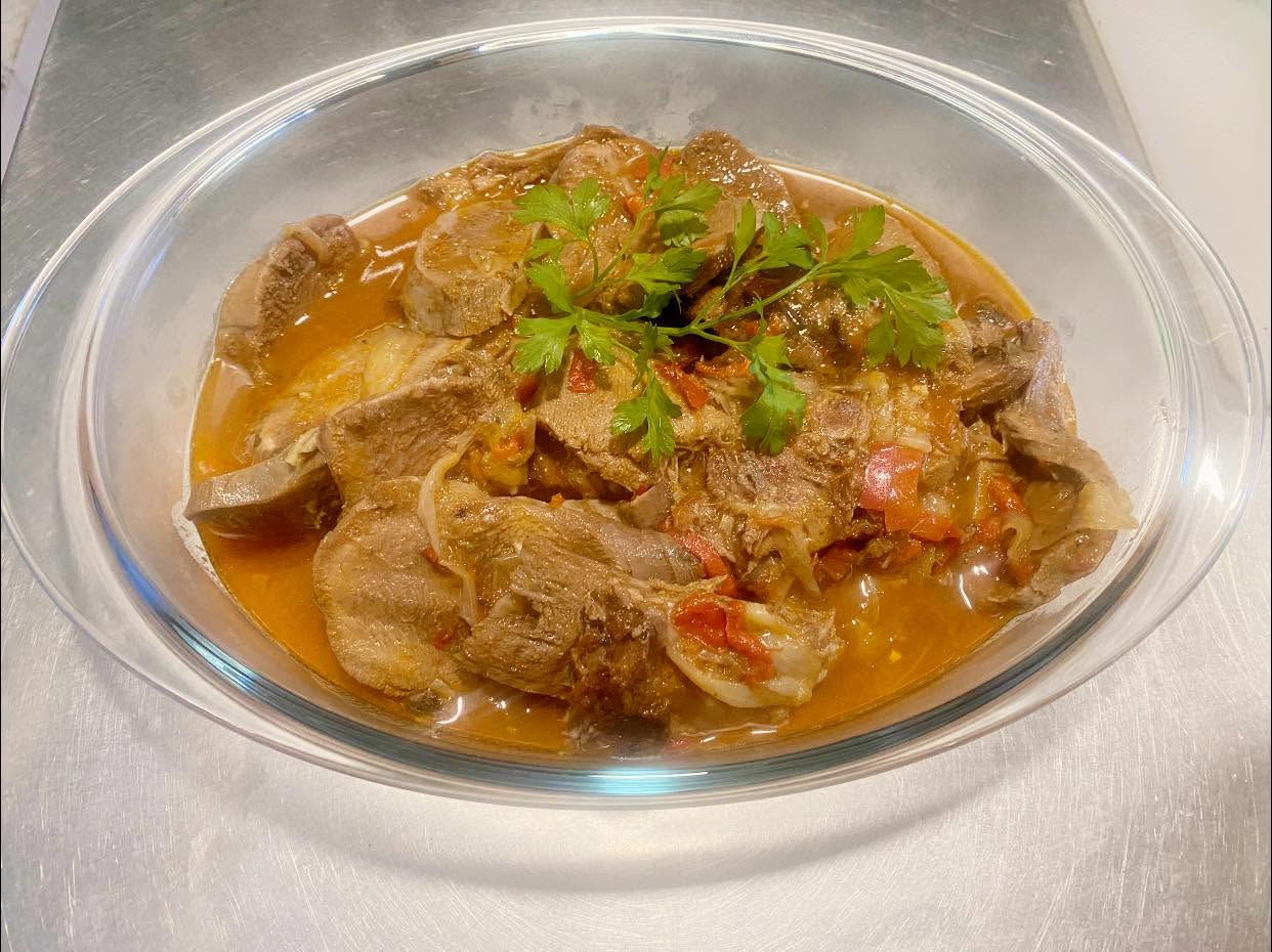 Slow-braised lamb in a tomato and pepper sauce with parsley