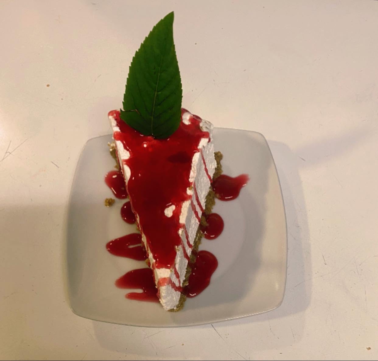Cheesecake with red fruit coulis