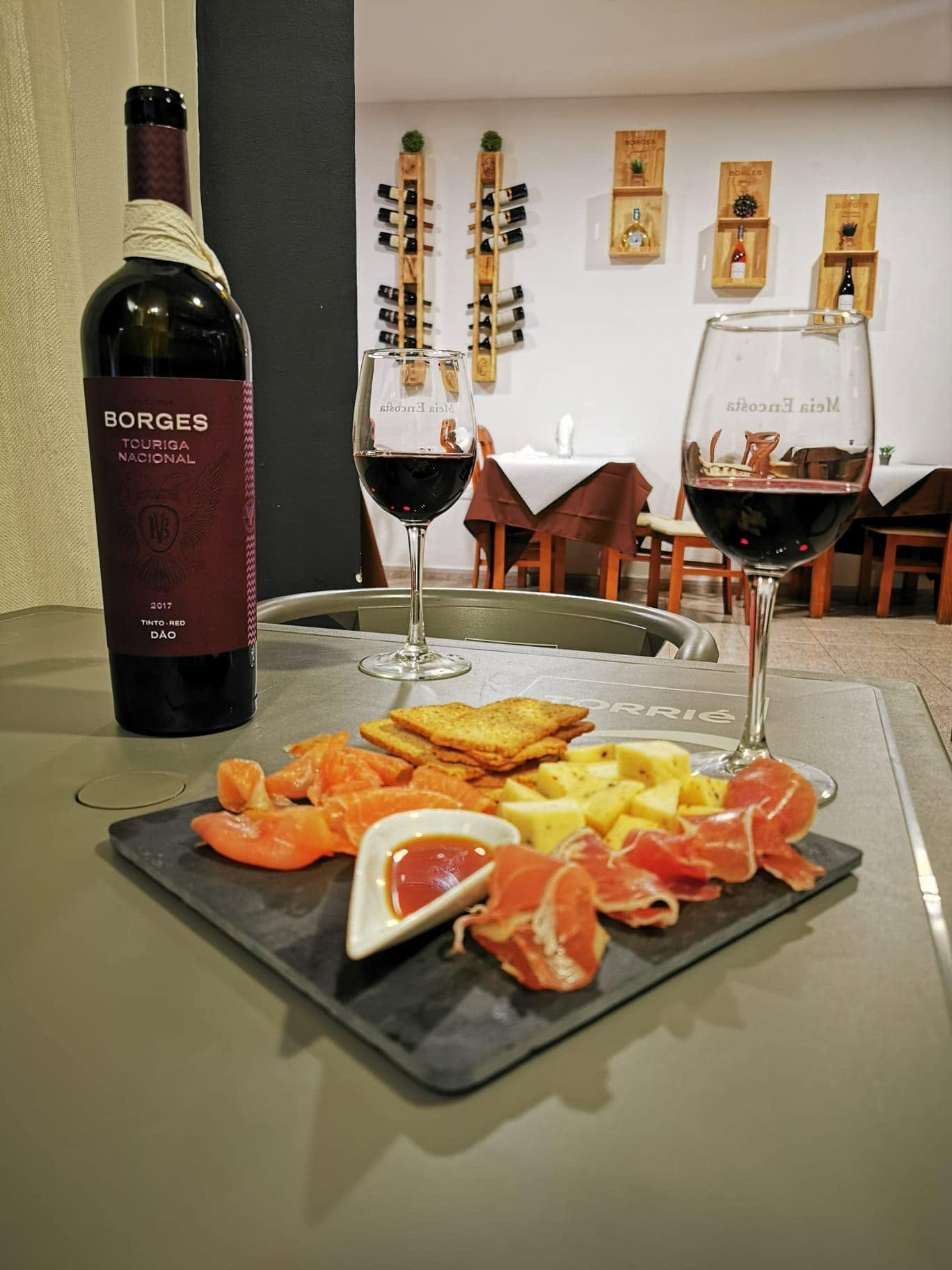 Bottle of Borges Touriga Nacional Dão with two glasses of red wine and a sharing board