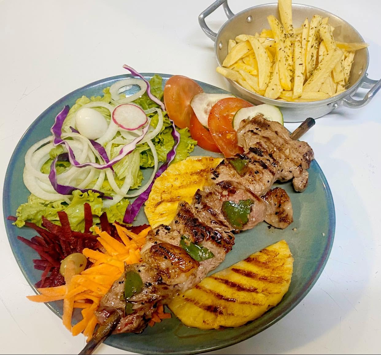 Beef espetada skewer with grilled pineapple and fries